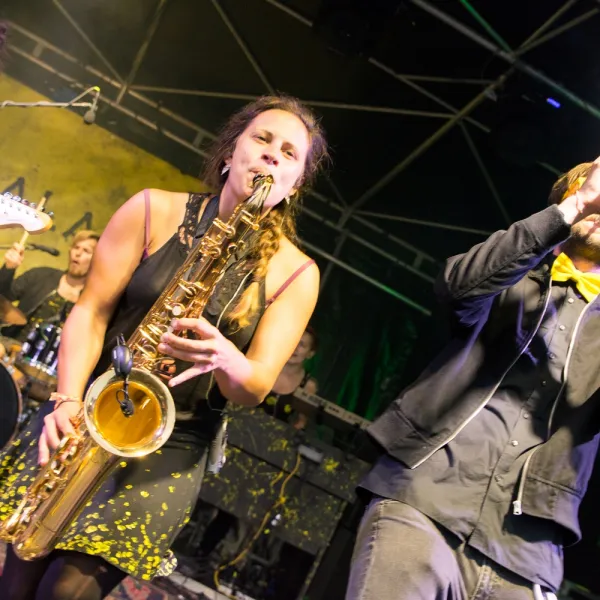 Live-Band mit Saxophonistin und Trompeter beim Open-Air-Auftritt.