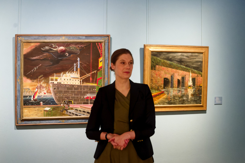 Ina Grätz vor Gemälden von Franz Radziwill ("Wo der Baum nicht mehr wächst, ist Gott auch" und "Siel bei Petershörn")