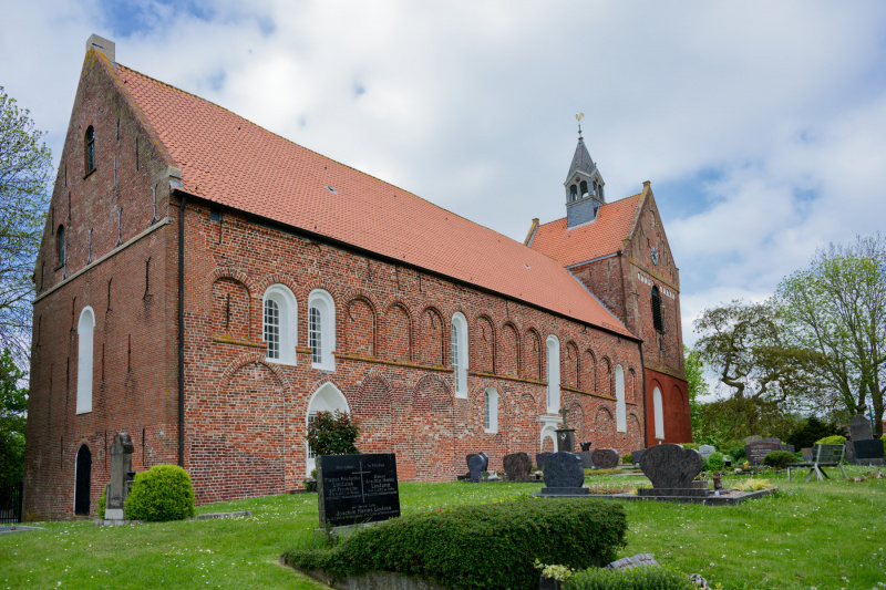 Überwiegend bewölkter Himmel: Die Kirche in Eilsum